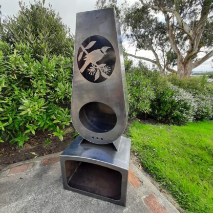 Tui corten outdoor fireplace brazier in chiminea shape with wood storage made with New Zealand steel - side